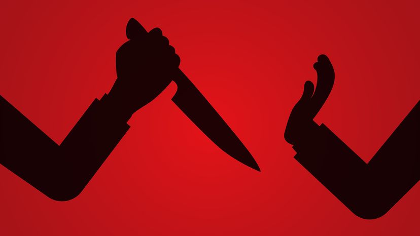 Illustrated&nbsp; silhouette of one person attacking another with a knife against a red background