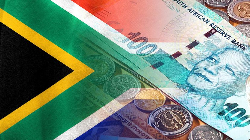 South African flag and South African Rand cash bills and coins