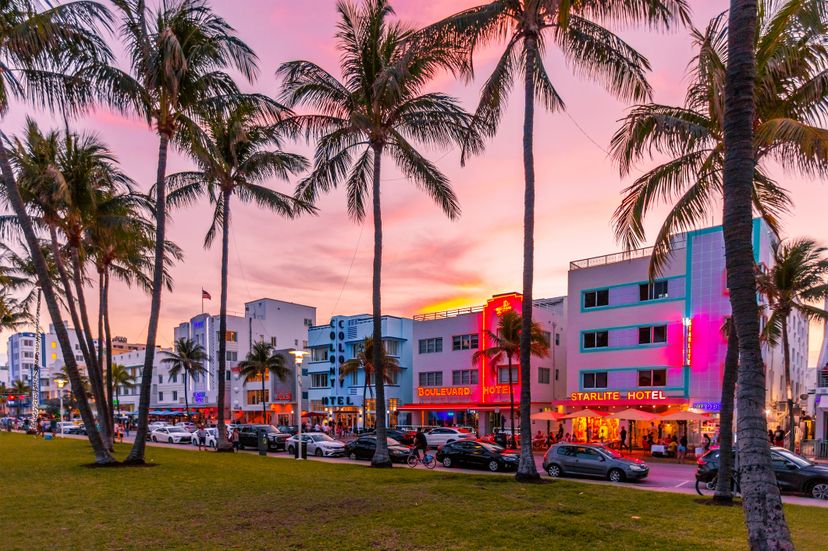 Neon illuminated Ocean Drive at sunset, South Beach, Miami, USA