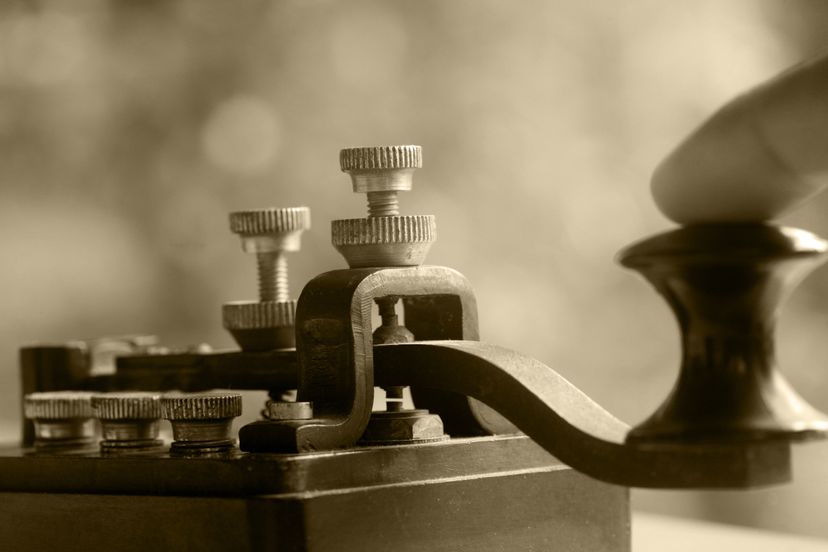 A close-up of a finger tapping a telegraph transmitter