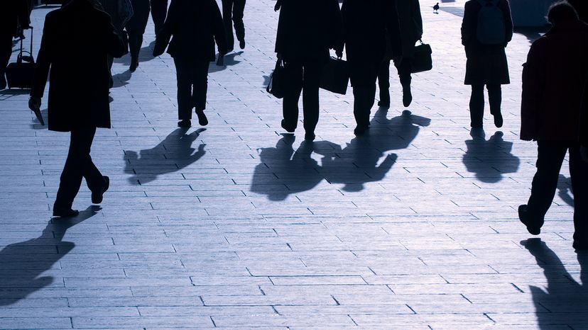 Shadows of office workers walking by