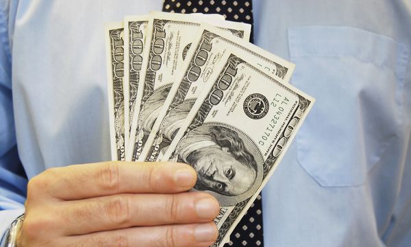 man holding dollar bills