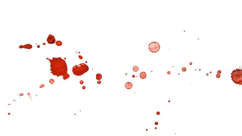 Drops and splatters of red on a white background