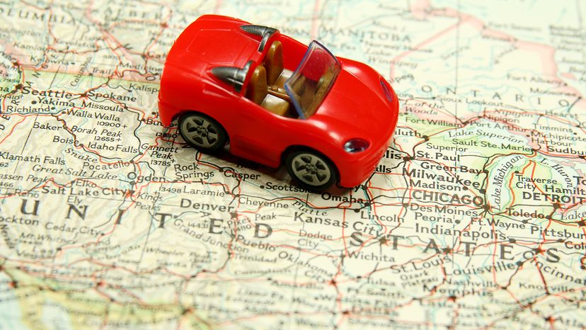 Red toy car on a map of the United States