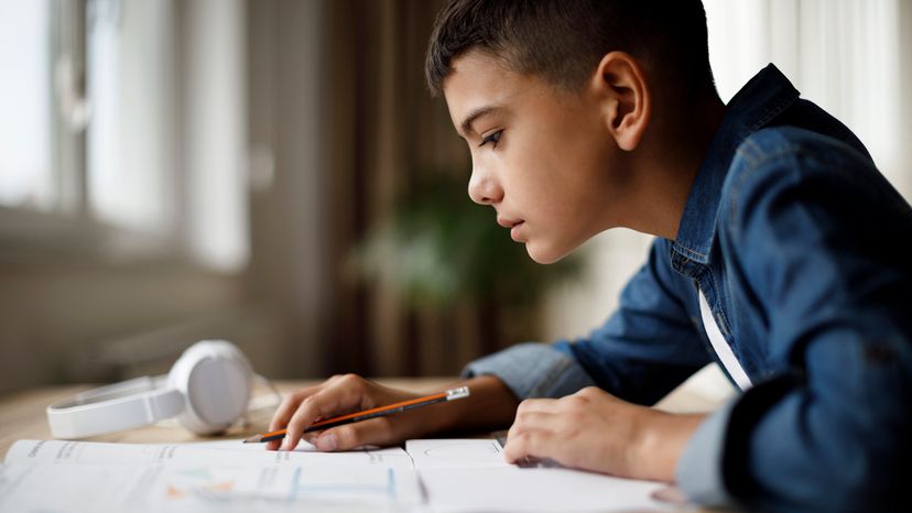 Young boy doing homework at a desk