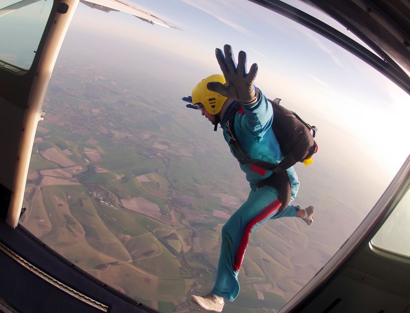 parachutist jumps through the door of the plane