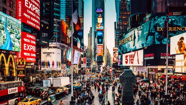 Manhattans iconic Times Square and Theater District seen in the evening, view bearing South