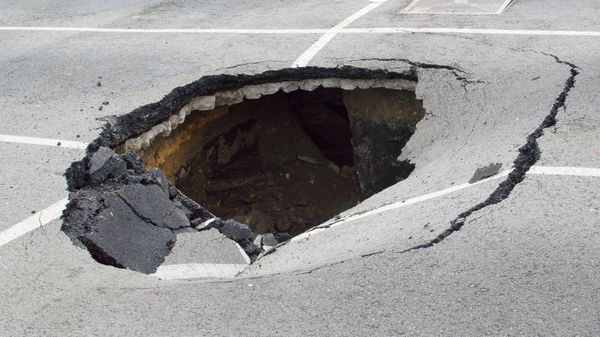 A hole 2-3 feet deep in the middle of a parking lot