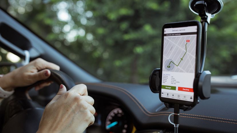 Delivery woman  using mobile phone to locate customer