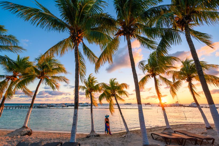 Woman admiring the sunset on the Caribbean sea, Mexico