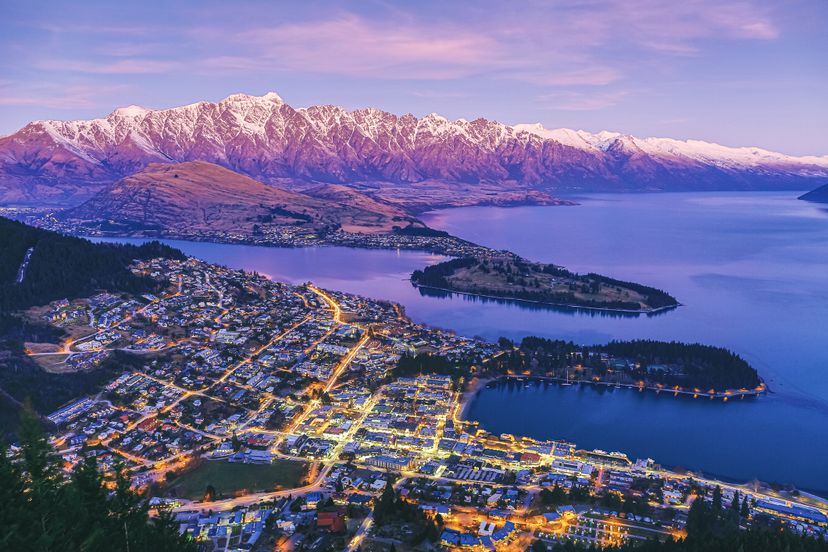 Scenic dusk view of illuminated Queenstown cityscape at beautiful sunset