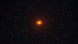 Bright red glowing spot in the night sky