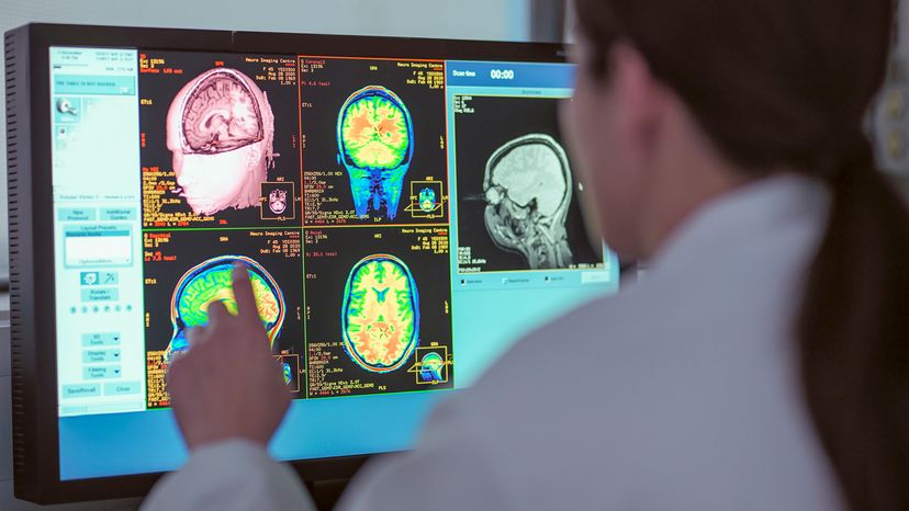 UK, North Yorkshire, Female doctor looking at MRI scanner monitor