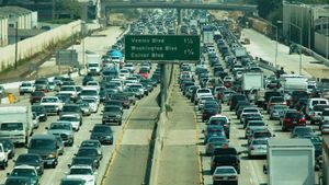 Bumper-to-bumper traffic in both directions on the Interstate 405 in Los Angeles. Sign marks exits to Venice, Washington and Culver Boulevards.