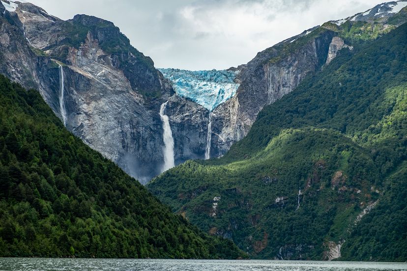 A glacier melts into coastal waterfalls