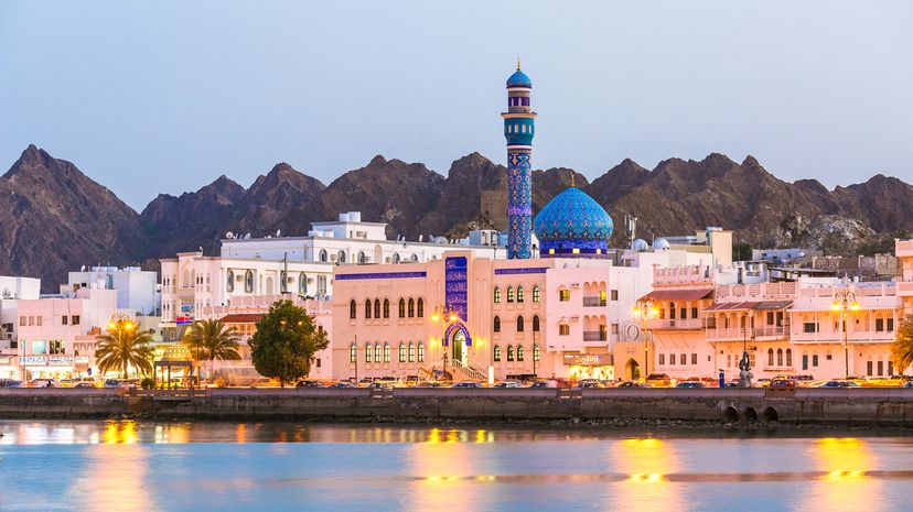 Sunset view of Oman skyline from the water