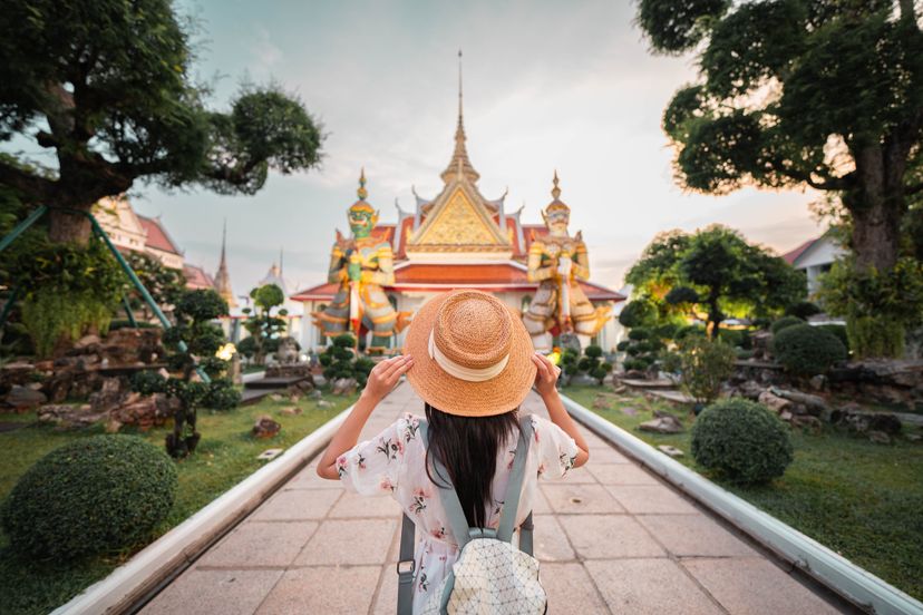 Adventure Asian beautiful tourist women travel in the buddha temple back view in Bangkok Thailand