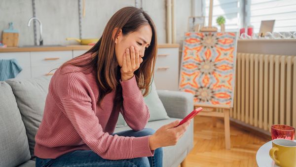 Young woman receiving shocking message