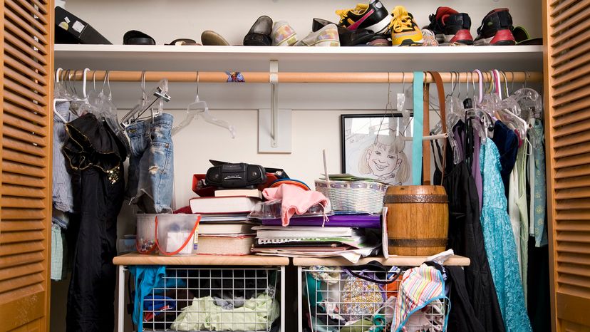 Doors open on a messy closet