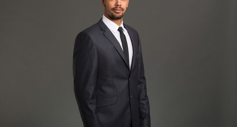 Studio shot of a well dressed young businessman on a grey background.