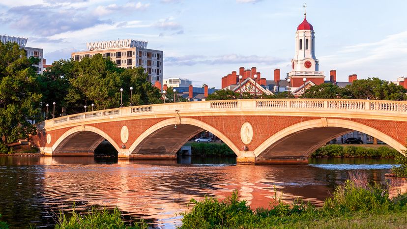 A red brick bridge over a river on a clear day