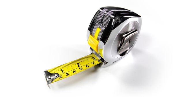 Builder's tape measure extended three inches