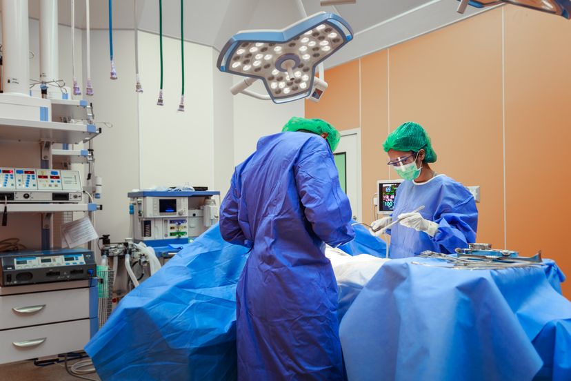 Doctor And Nurse Suture Patient In Emergency Room