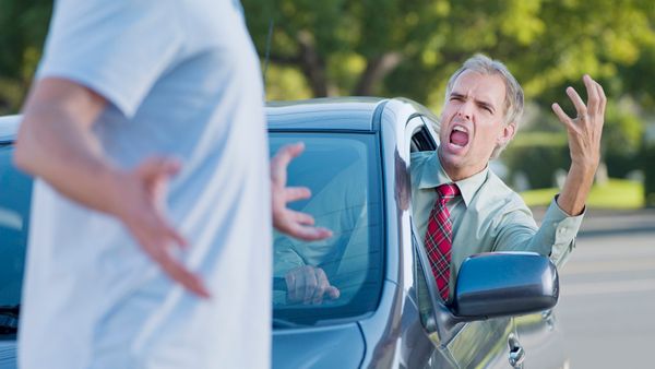An angry driver gestures at a pedestrian