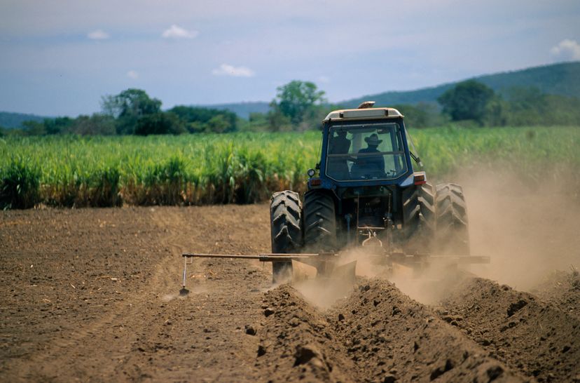 A tractor with pneumatic tires drives across a field.