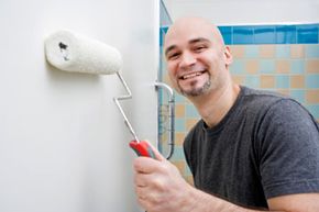 man painting bathroom