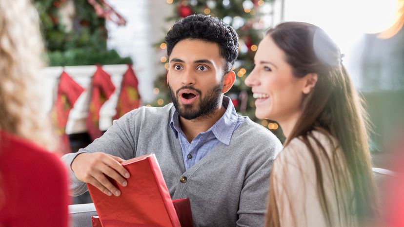 man opening Christmas gift