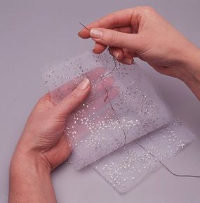 Sew running stitches through center of netting.
