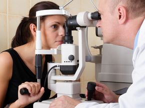 A doctor tests for glaucoma during an eye exam.