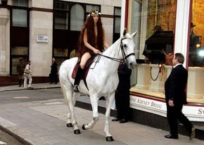 A modern Lady Godiva makes her way down a London sidewalk. This Godiva is clearly a redhead, but historians don't know if Godgifu had red, blond or brown hair.