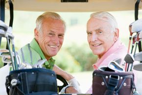 Senior citizens in golf cart with clubs