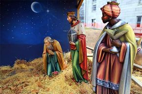 Two wise men look at Joseph kneeling, as Mary and Jesus are no longer there. They were stolen along with two other figures from a Nativity display next to Quincy City Hall, Boston in 2013. 