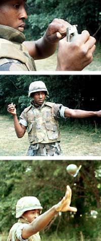 The proper way to throw a hand grenade: Depress the striker lever, pull the pin, hurl the grenade.