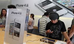 An Apple Store customer looks at the new Apple iPhone 4Gs on October 14, 2011 in San Francisco.