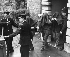 Three of the suspects arrested in connection with the Great Train Robbery are photographed leaving Linslade court with blankets over their heads.