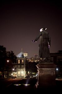 nighttime images of statue, city