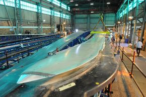 A 164-foot (50-meter) wind turbine blade comes to life in a Cape Town, South Africa, factory.