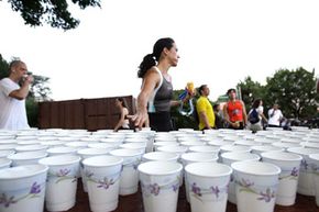 Empty water cups are just some of the waste organizers of "green" triathlons are trying to reduce.”width=