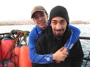 A greenhorn embrace -- deckhand Jake Harris and greenhorn Joshua Harris, onboard an Alaskan king crab boat