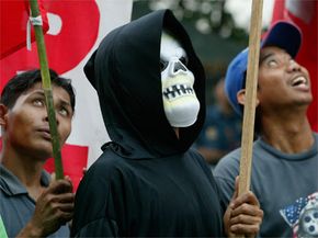 Protesters often don a Grim Reaper costume to make a point. This one is demonstrating against the presence of the International Monetary Fund and the World Bank during a rally in the Philippines in October 2004.