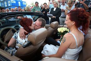 Even unusual weddings, like this mass Rockabilly drive-in wedding in Sweden in 2008, feature old traditions. See more pictures of kissing.