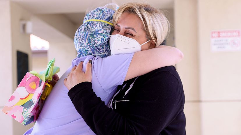 Surab Nasrallah (right) hugs executive director Margarita Kechichian before visiting her father on the first day of in-room family member visits at the Ararat Nursing Facility in the Mission Hills March 24, 2021 in Los Angeles. 