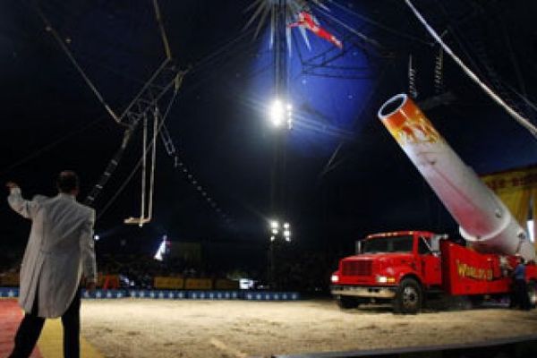 human cannonball being shot from truck in circus ring