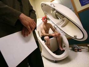 A test subject sits in a body composition assessment machine called a bop pod at Fort Campbell Army Base's Injury Prevention and Performance Enhancement Laboratory in Fort Campbell, Ky.