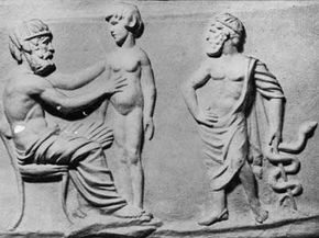 A cast taken from an ancient Greek intaglio gem depicts a physician examining a patient while Asclepius, the god of healing, stands nearby holding the symbol of medicine, a snake coiled round a staff.