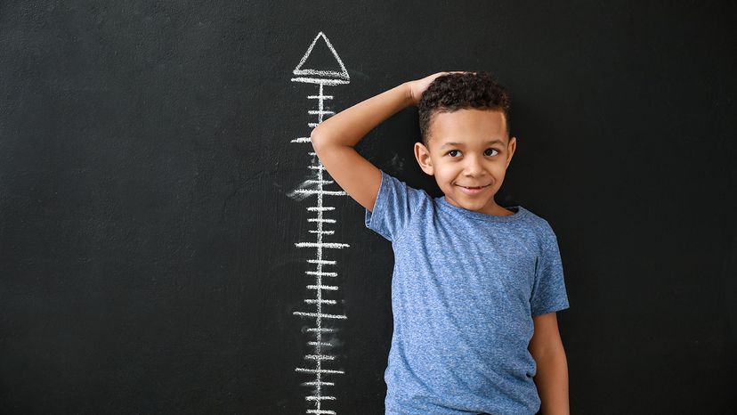 young African American boy at height chart